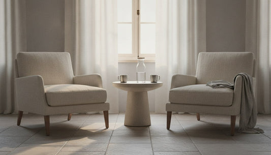 Backs of two wooden chairs by a bright window